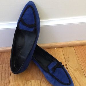 Dark blue suede flats, gently worn, a little heel